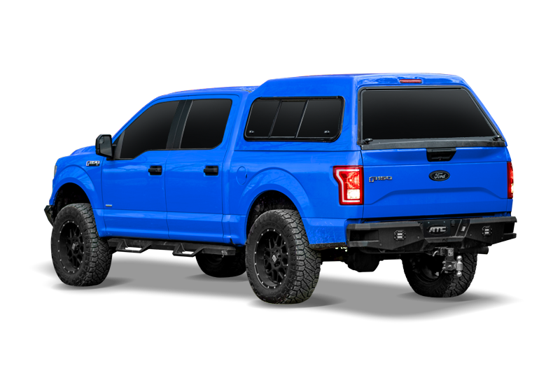 blue ford f150 with a mid-rise truck cap